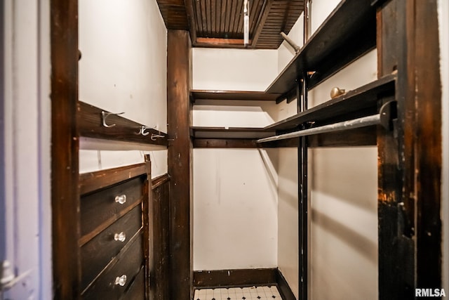 walk in closet with tile patterned floors