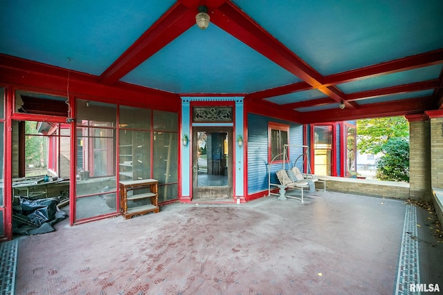 unfurnished sunroom with beamed ceiling