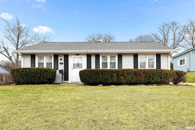 ranch-style home with a front yard and a shingled roof