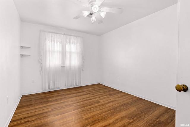 empty room with baseboards, ceiling fan, and wood finished floors