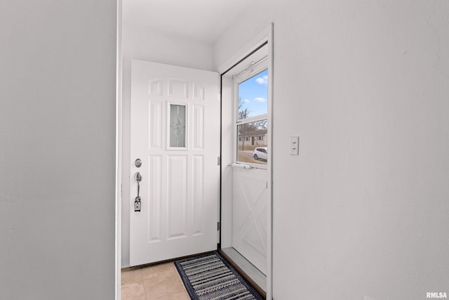 doorway to outside featuring light tile patterned flooring