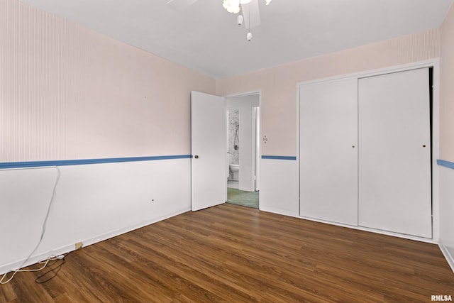 unfurnished bedroom with a closet, wood finished floors, and a ceiling fan