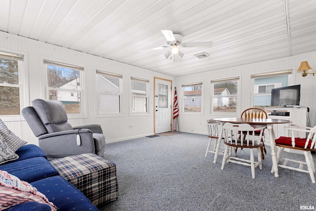 sunroom with a ceiling fan and visible vents