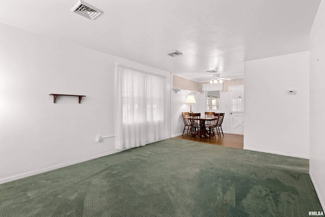 unfurnished dining area featuring visible vents, carpet floors, baseboards, and ceiling fan