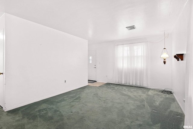 empty room with carpet flooring and visible vents