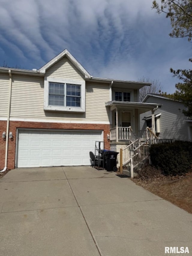 view of front facade with a porch, an attached garage, brick siding, and driveway