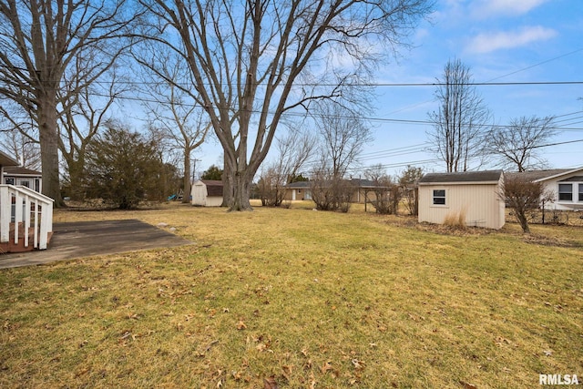 view of yard with a storage shed and an outdoor structure