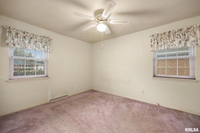 carpeted spare room featuring visible vents, baseboards, and ceiling fan