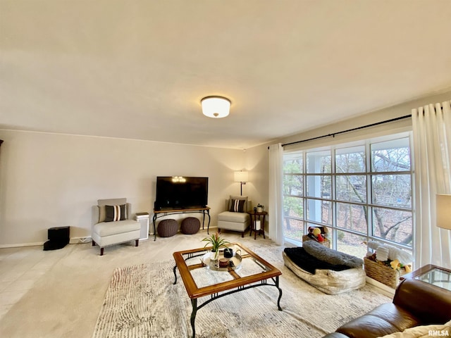 carpeted living room with baseboards