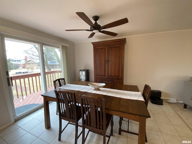 dining space with light tile patterned floors and a ceiling fan