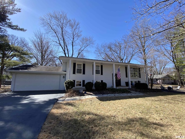 split foyer home featuring a garage, driveway, and a front lawn