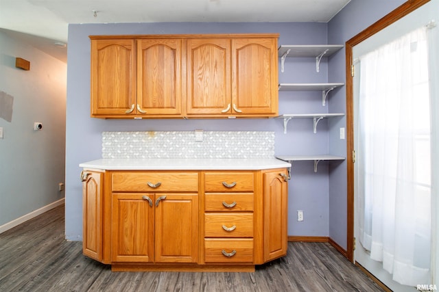 kitchen featuring decorative backsplash, baseboards, dark wood finished floors, and light countertops