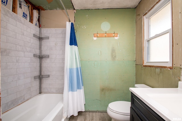 bathroom featuring vanity, toilet, wood finished floors, and shower / bath combo with shower curtain