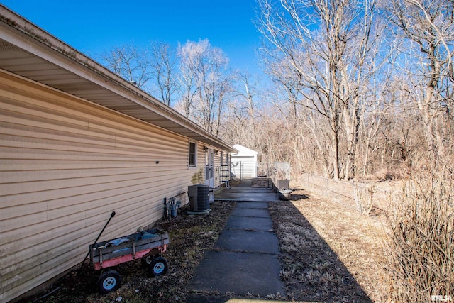 view of home's exterior featuring an outbuilding and central AC unit