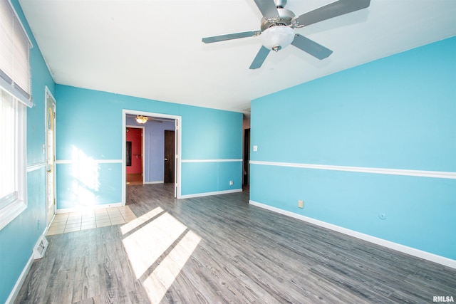 unfurnished room with wood finished floors and baseboards