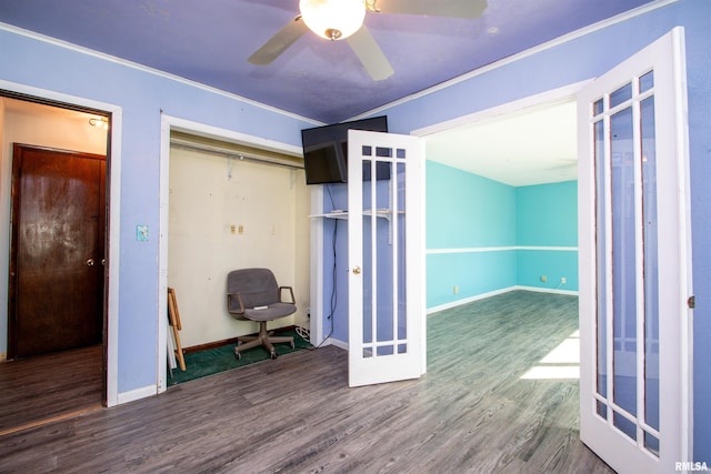 unfurnished bedroom featuring a closet, crown molding, baseboards, and wood finished floors