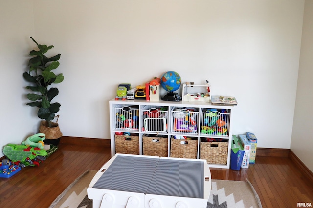 playroom with baseboards and wood-type flooring