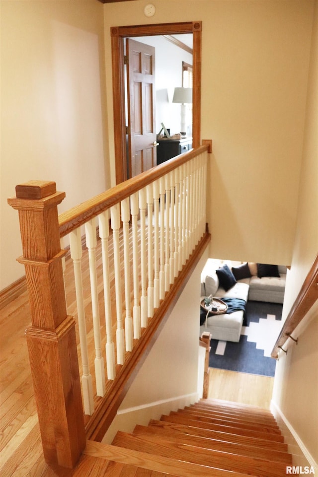 staircase with wood finished floors and baseboards