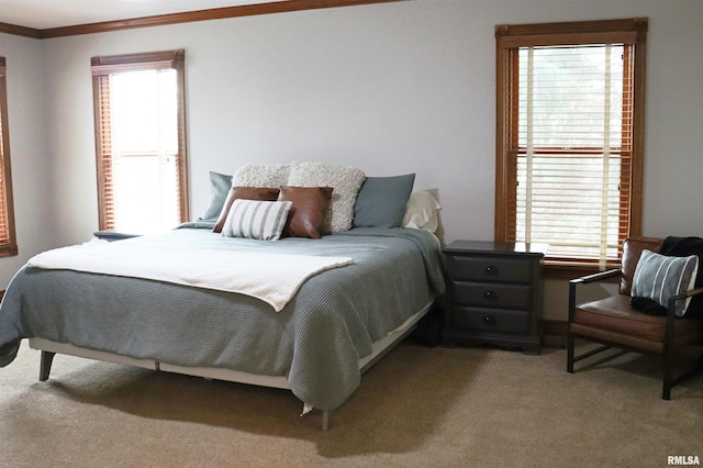 bedroom featuring crown molding and light carpet