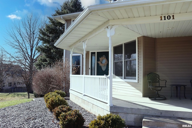 view of side of home with covered porch