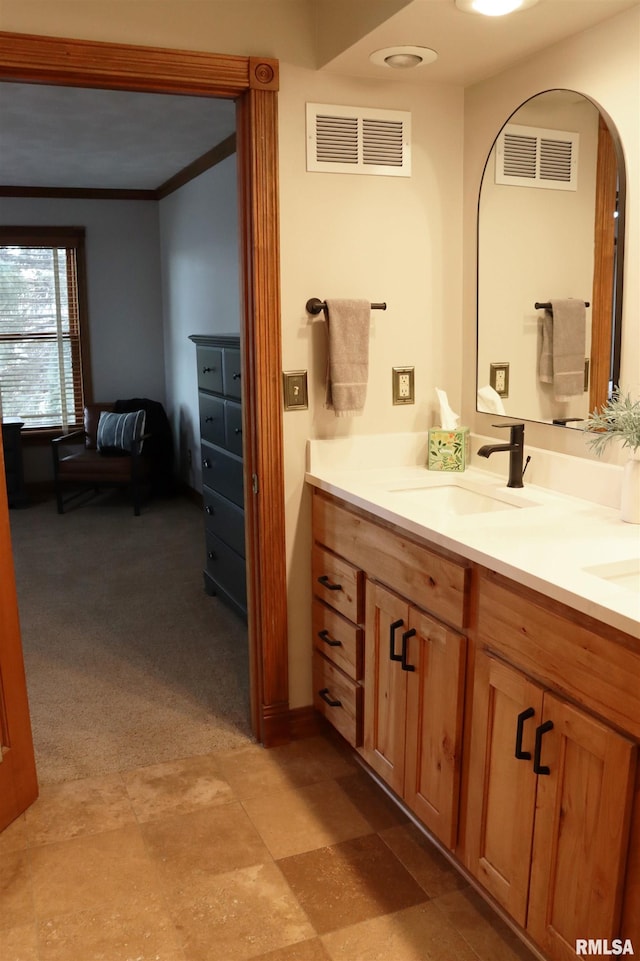 bathroom featuring vanity, crown molding, and visible vents