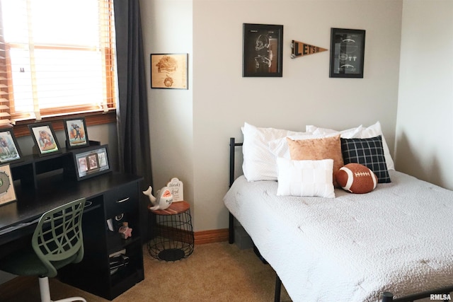 bedroom with carpet flooring and baseboards