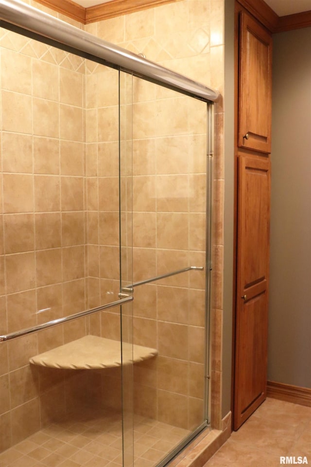 full bath with a shower stall and baseboards