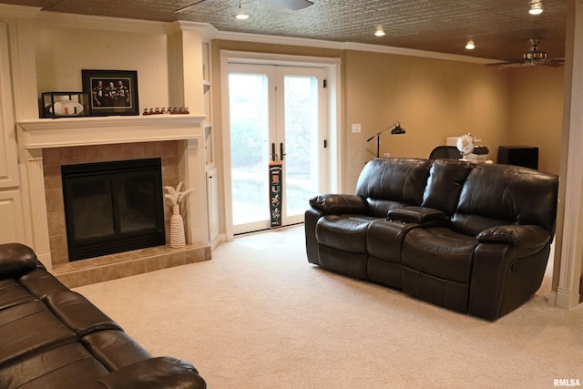 living room featuring carpet, ceiling fan, and a fireplace