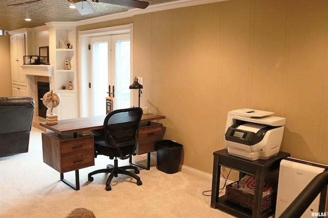 office space featuring french doors, carpet, ornamental molding, and a tile fireplace