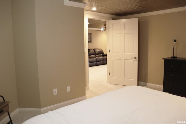 bedroom featuring light carpet, an ornate ceiling, baseboards, and ornamental molding