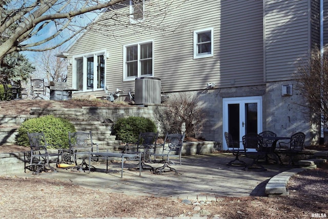 back of property with central air condition unit, french doors, and a patio area