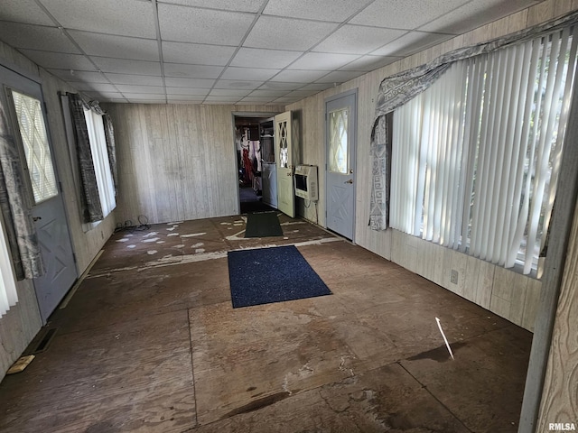 foyer featuring heating unit and a paneled ceiling