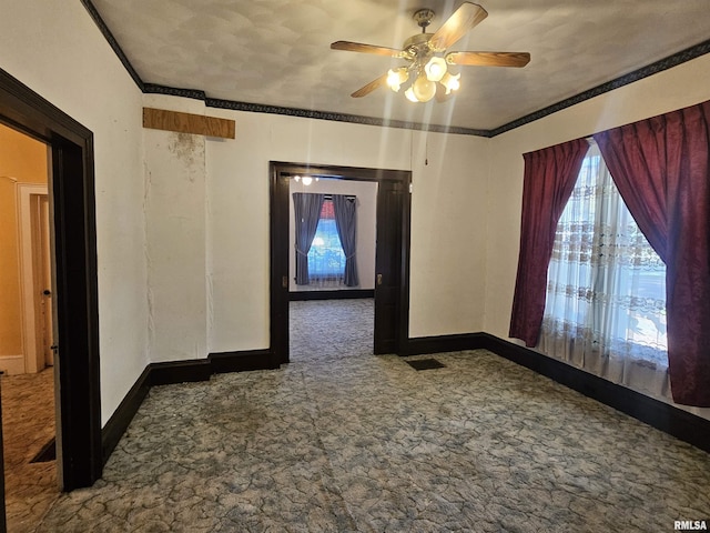 carpeted empty room with baseboards and ornamental molding