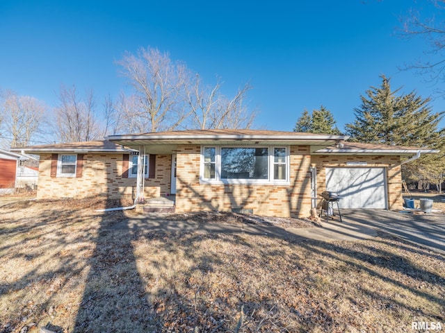 view of front of property featuring brick siding, concrete driveway, and a garage