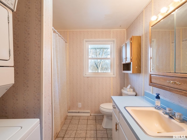 full bathroom featuring toilet, a baseboard heating unit, wallpapered walls, stacked washer / drying machine, and vanity