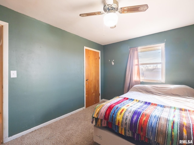 bedroom with ceiling fan, baseboards, and carpet floors