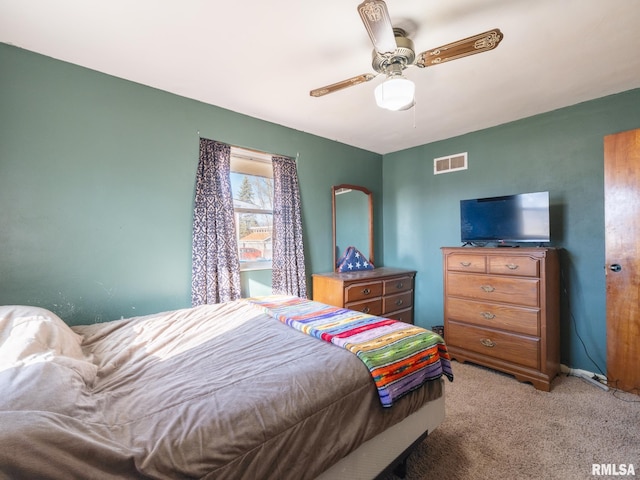 bedroom with a ceiling fan, light colored carpet, visible vents, and baseboards