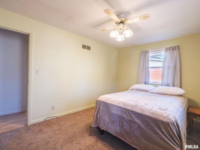 bedroom with visible vents, carpet flooring, a ceiling fan, and baseboards