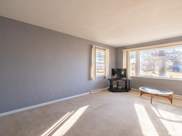 unfurnished room with baseboards, a wealth of natural light, and carpet floors