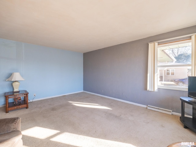 carpeted spare room featuring a baseboard heating unit and baseboards