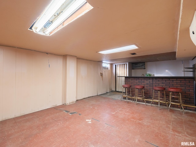 interior space with tile patterned floors and a bar