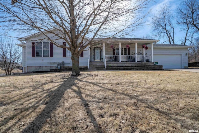 ranch-style home featuring driveway, a front lawn, a porch, and an attached garage