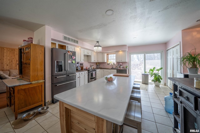 2268 E Knox St, Galesburg, IL 61401 - kitchen featuring visible vents, a sink, stainless steel appliances, white cabinets, and light tile patterned floors