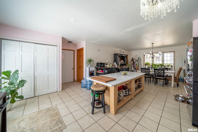 2268 E Knox St, Galesburg, IL 61401 - kitchen featuring light tile patterned floors, an inviting chandelier, light countertops, decorative light fixtures, and a center island