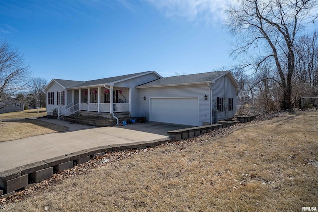 ranch-style home featuring concrete driveway, a garage, covered porch, and a front yard