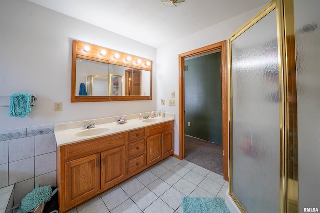 2268 E Knox St, Galesburg, IL 61401 - bathroom featuring a sink, tile walls, a shower stall, tile patterned flooring, and double vanity