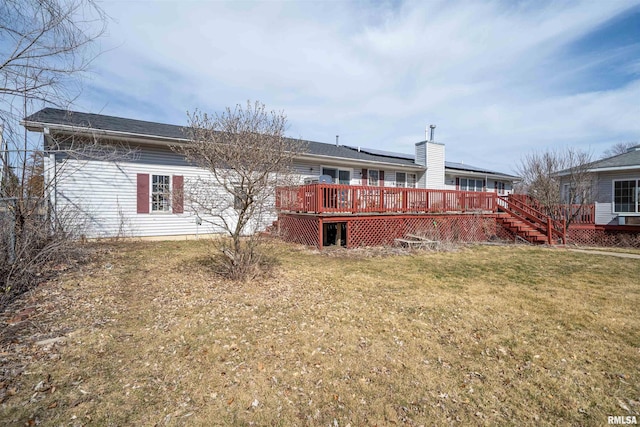 2268 E Knox St, Galesburg, IL 61401 - back of property with a wooden deck, roof mounted solar panels, a lawn, and stairs