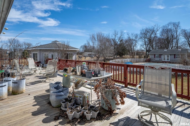 2268 E Knox St, Galesburg, IL 61401 - wooden deck with an outdoor structure, outdoor dining area, fence, and a storage structure