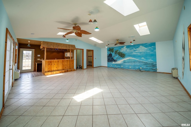 2268 E Knox St, Galesburg, IL 61401 - unfurnished living room with vaulted ceiling, light tile patterned floors, baseboards, and ceiling fan