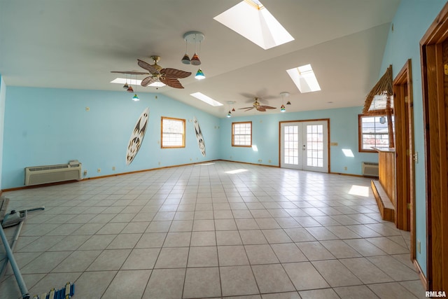 2268 E Knox St, Galesburg, IL 61401 - empty room featuring an AC wall unit, a ceiling fan, vaulted ceiling with skylight, light tile patterned floors, and baseboards